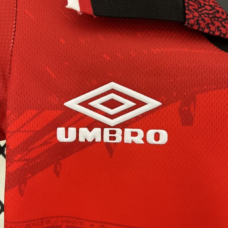 Red kid soccer jersey detail with Umbro logo and diamond emblem