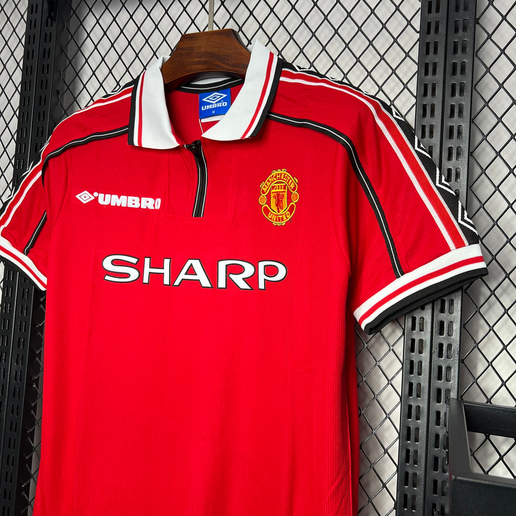 Red home soccer jersey front with white collar, Umbro logo, SHARP sponsor, and crest