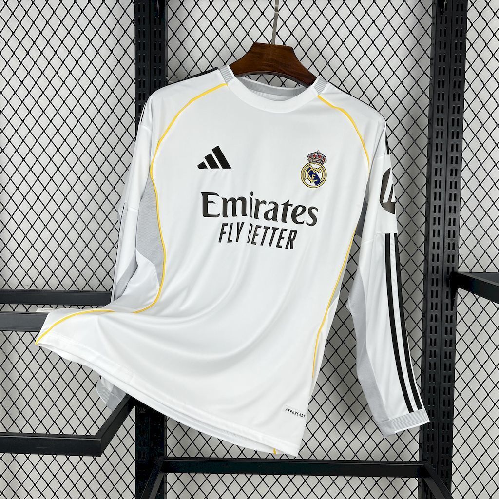 White long-sleeve football jersey with yellow trim and Real Madrid crest