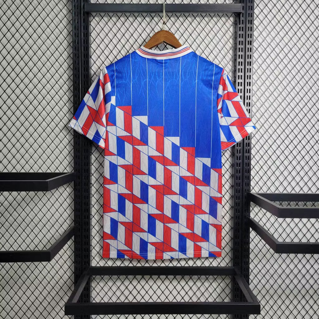 Blue retro football jersey back with red-and-white geometric stripe pattern, short sleeves