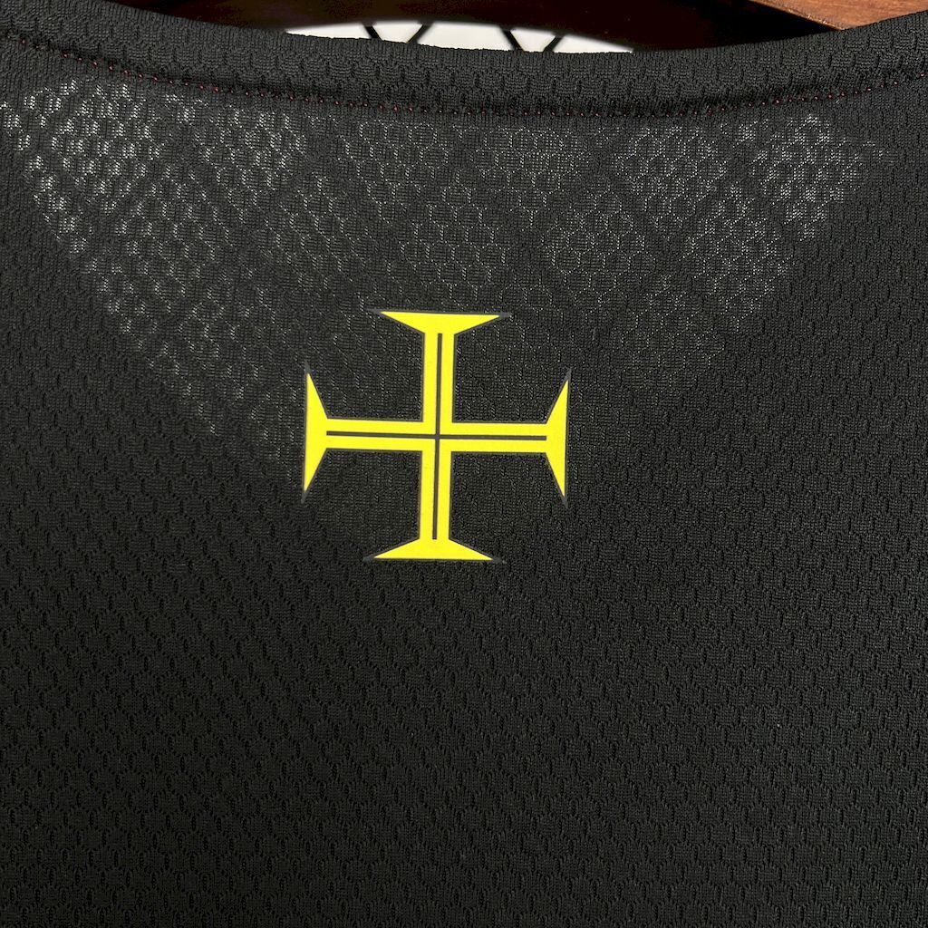 Yellow cross emblem on black textured jersey fabric