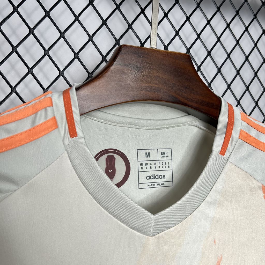 White football shirt neckline with orange trim and adidas size label