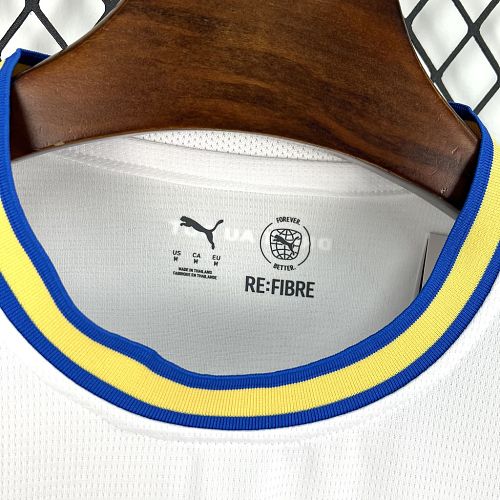 White football jersey neckline with blue/yellow trim and RE:FIBRE label