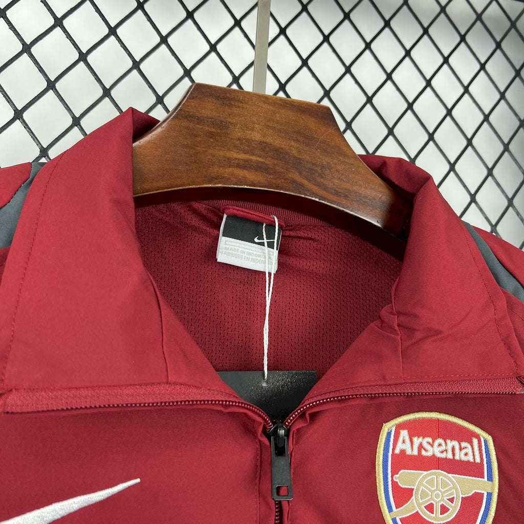 Red windbreaker jacket collar with black zipper and Arsenal crest near pocket