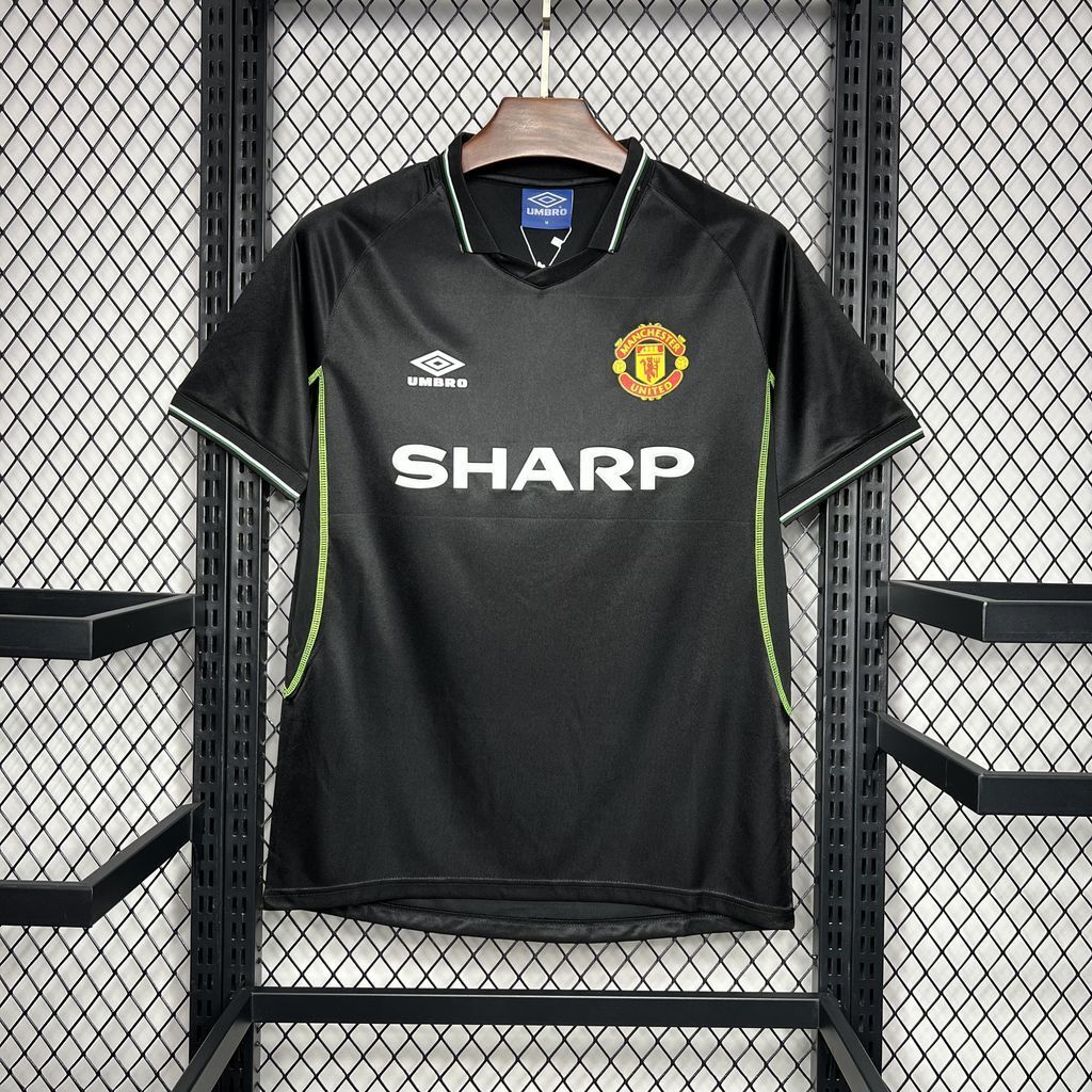 Black Manchester United third soccer jersey with SHARP sponsor, green-trim accents