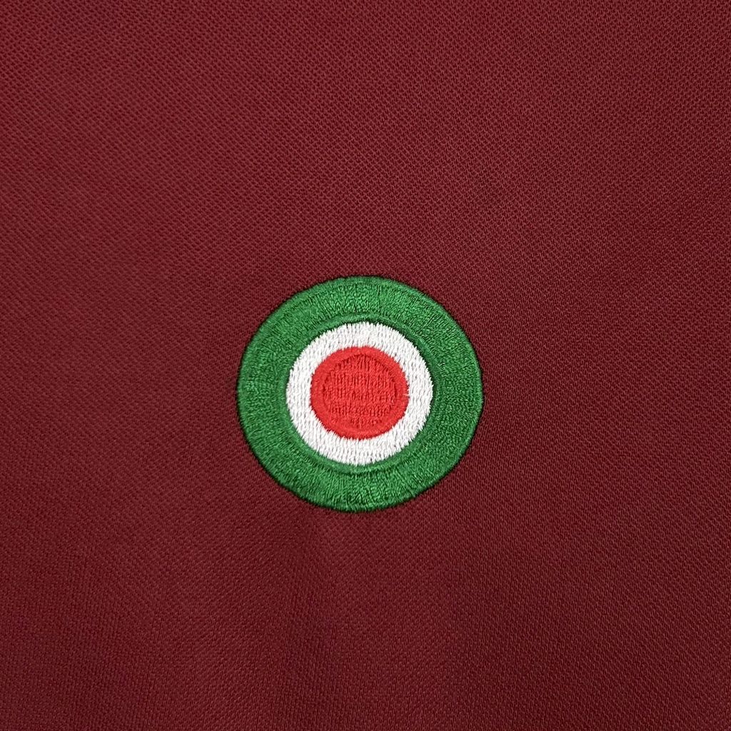 Maroon jersey with round green-white-red Roma crest badge