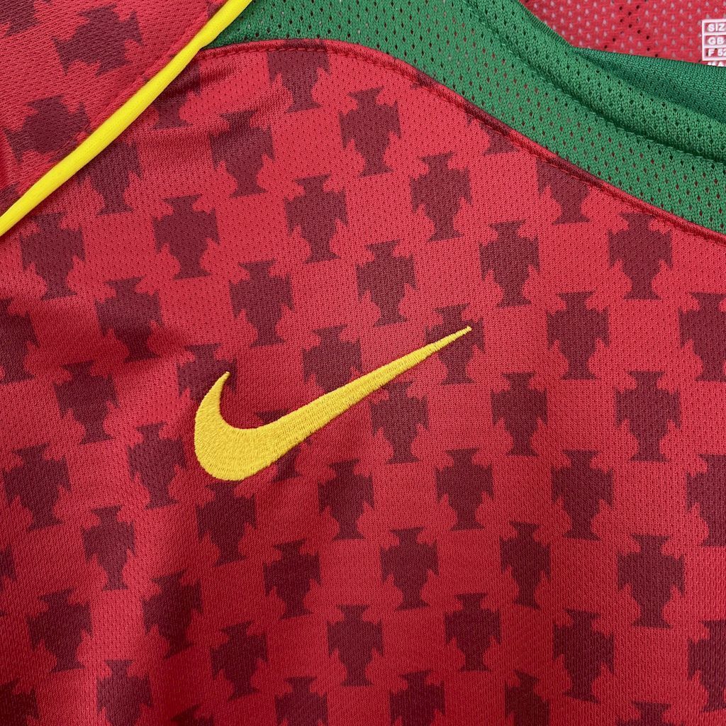 Nike swoosh on red retro football jersey with houndstooth pattern and green collar