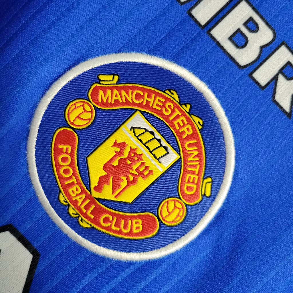 Manchester United crest patch on blue jersey fabric