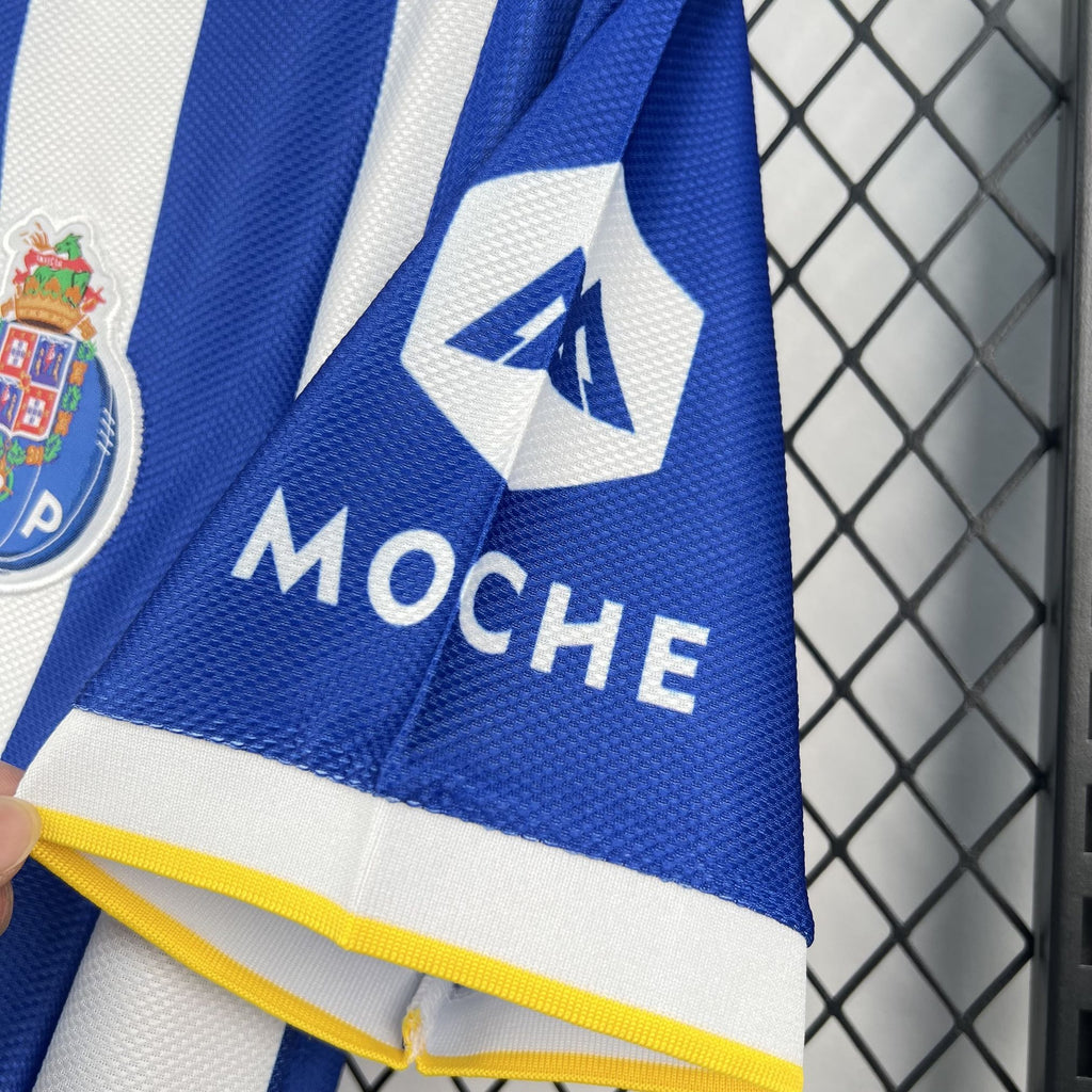 Soccer jersey sleeve with blue-and-white panels, “MOCH E” lettering, and yellow trim cuff