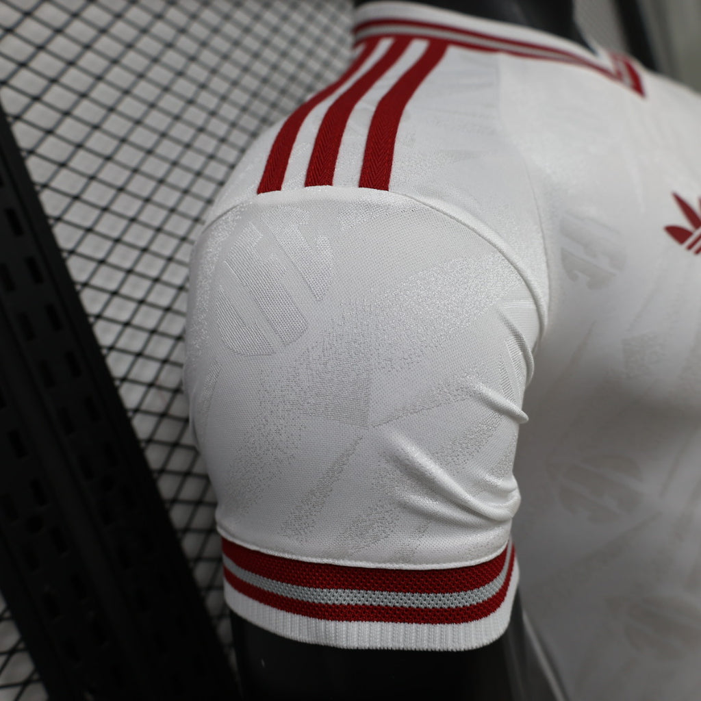 White jersey sleeve with red-and-white ribbed stripe trim at the cuff