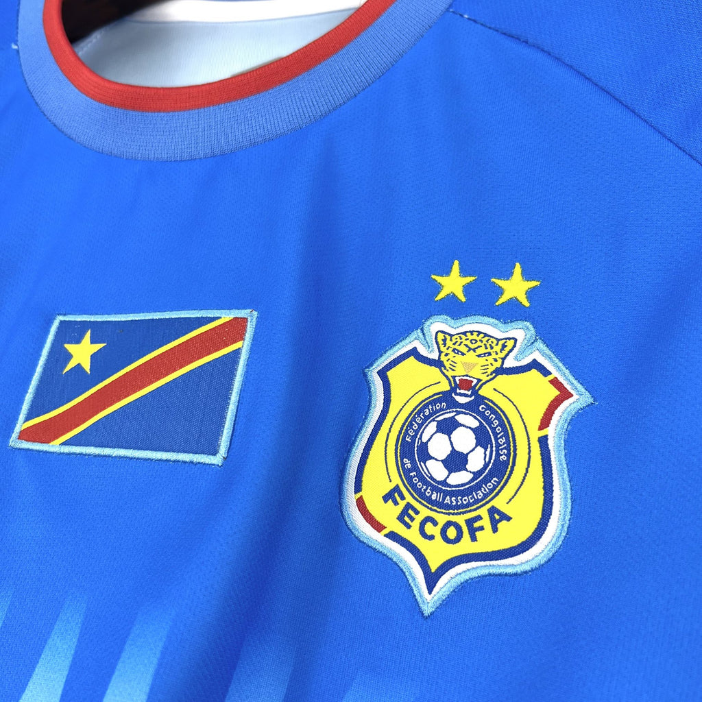 Blue Congo jersey close-up with flag patch, yellow stars, and soccer crest
