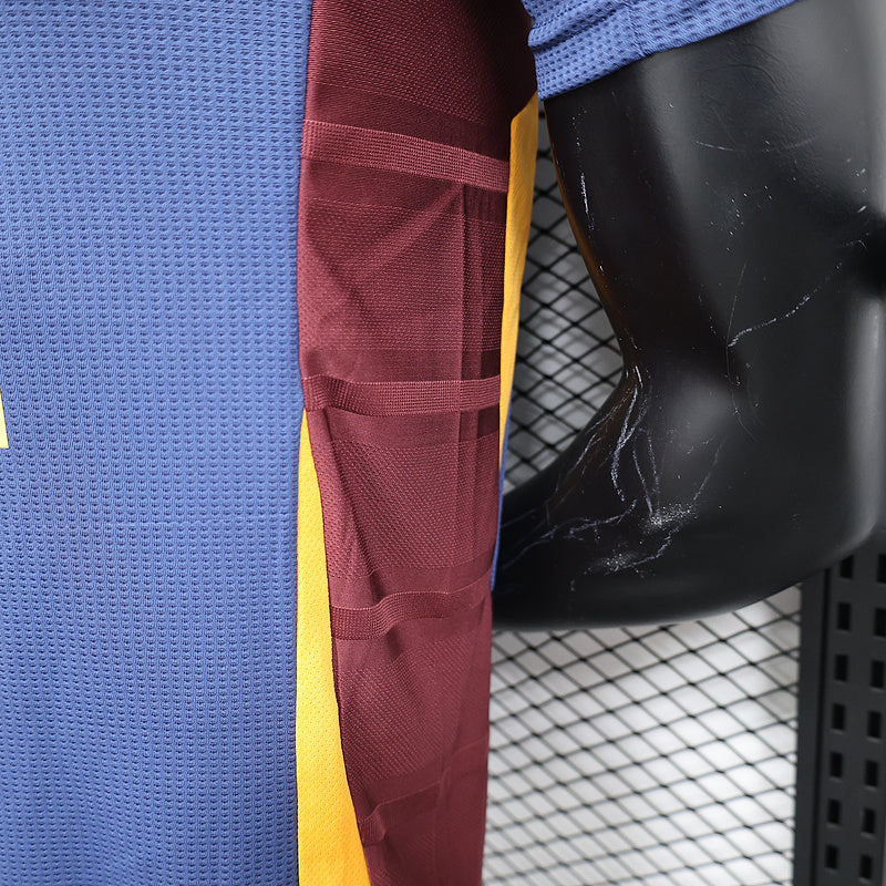 Maroon sleeve panel and yellow side accent on blue soccer jersey