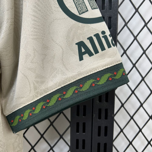 Cream jersey sleeve cuff with green band and colorful Oktoberfest-style trim
