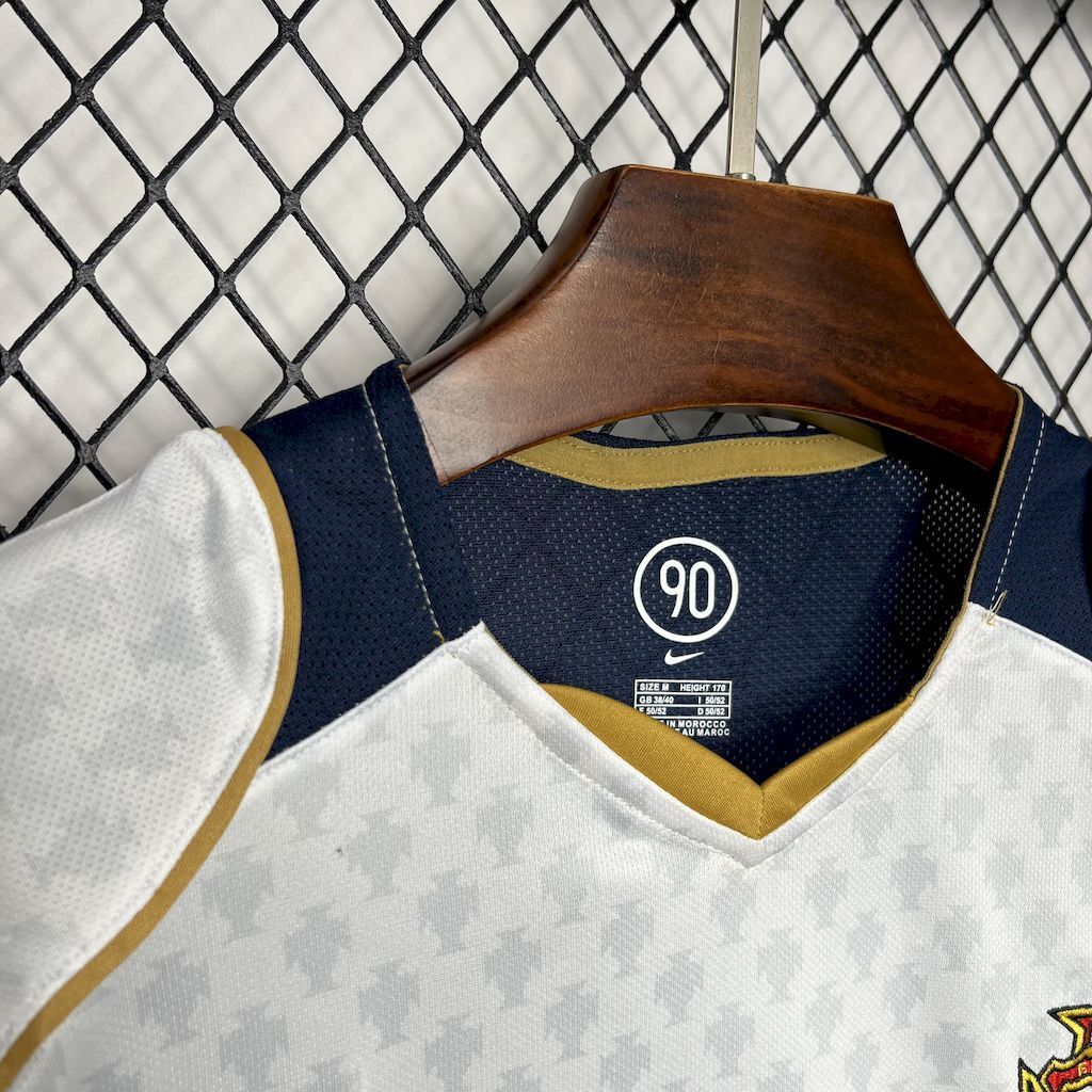 Portugal away jersey neckline with navy collar, 90 badge, and crest details