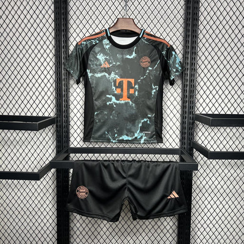 Kids away football kit: dark green graphic jersey with orange trim and matching shorts