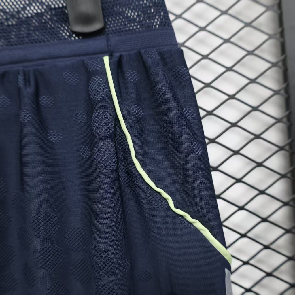 Navy player shorts with lime-trim piping and textured dot pattern