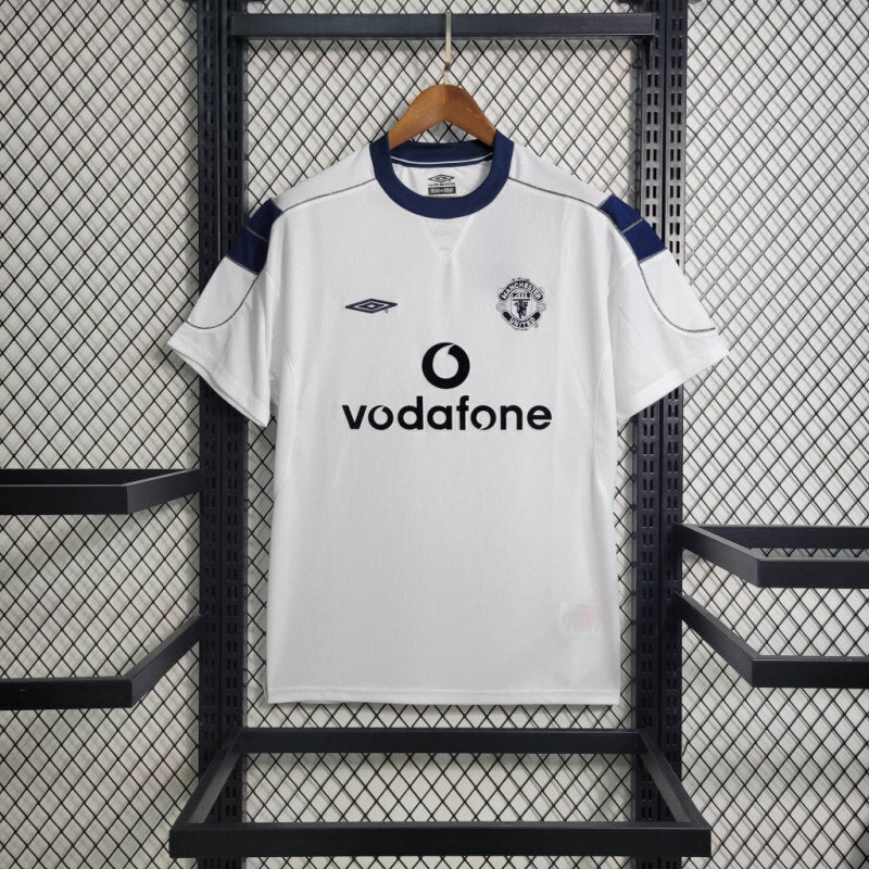 White soccer jersey with blue collar and sleeve panels; Vodafone sponsor and club crest