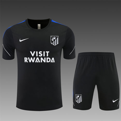 Black dark training jersey and shorts with blue piping, club crest, and VISIT RWANDA logo