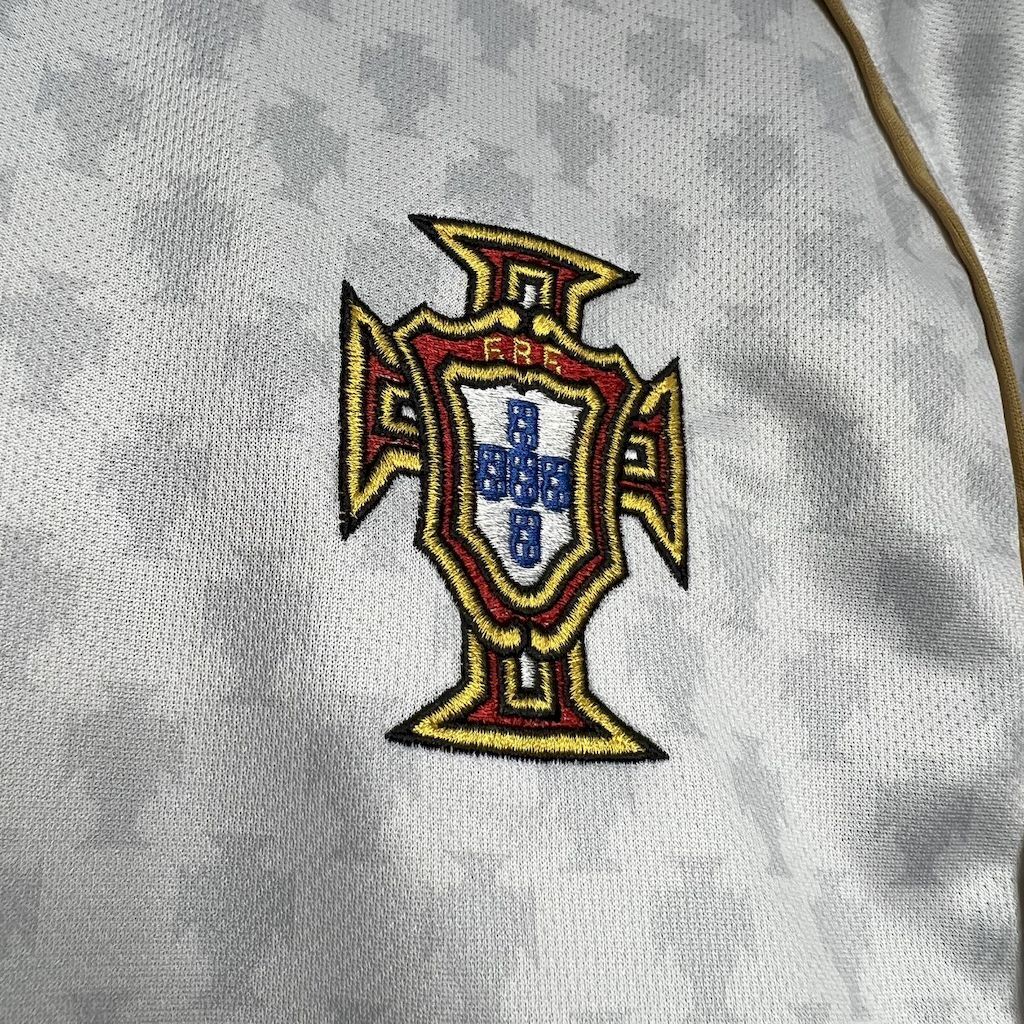 Portugal crest patch on white soccer jersey, colorful shield logo