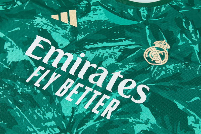 Green jersey with 'Emirates Fly Better' text and Real Madrid crest