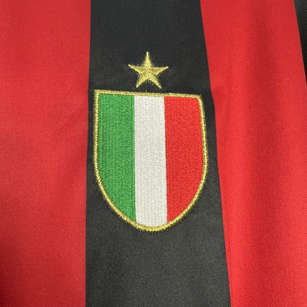 AC Milan crest patch on red and black striped jersey front with gold star detail