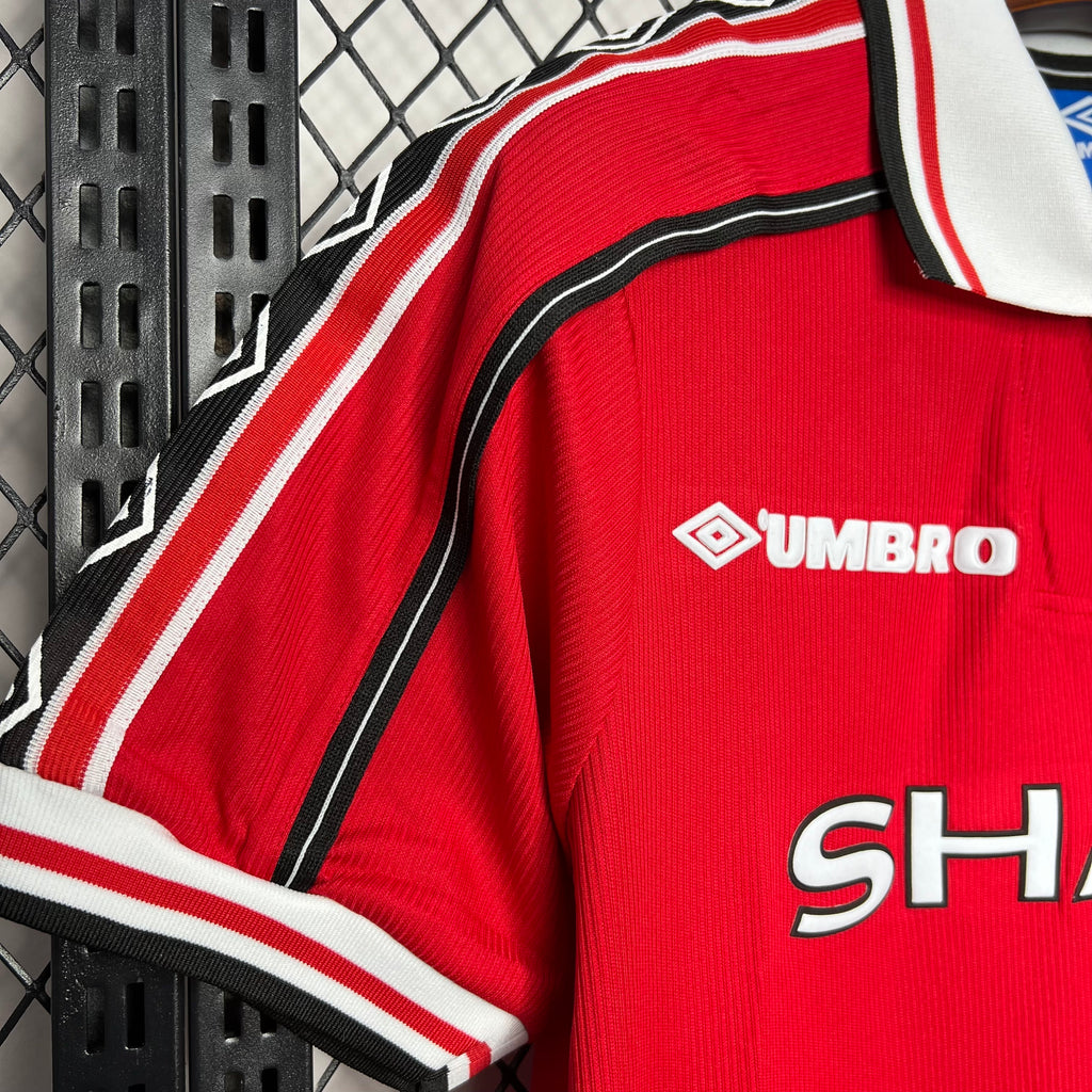 Red jersey sleeve and shoulder stripes with Umbro logo detail and black trim