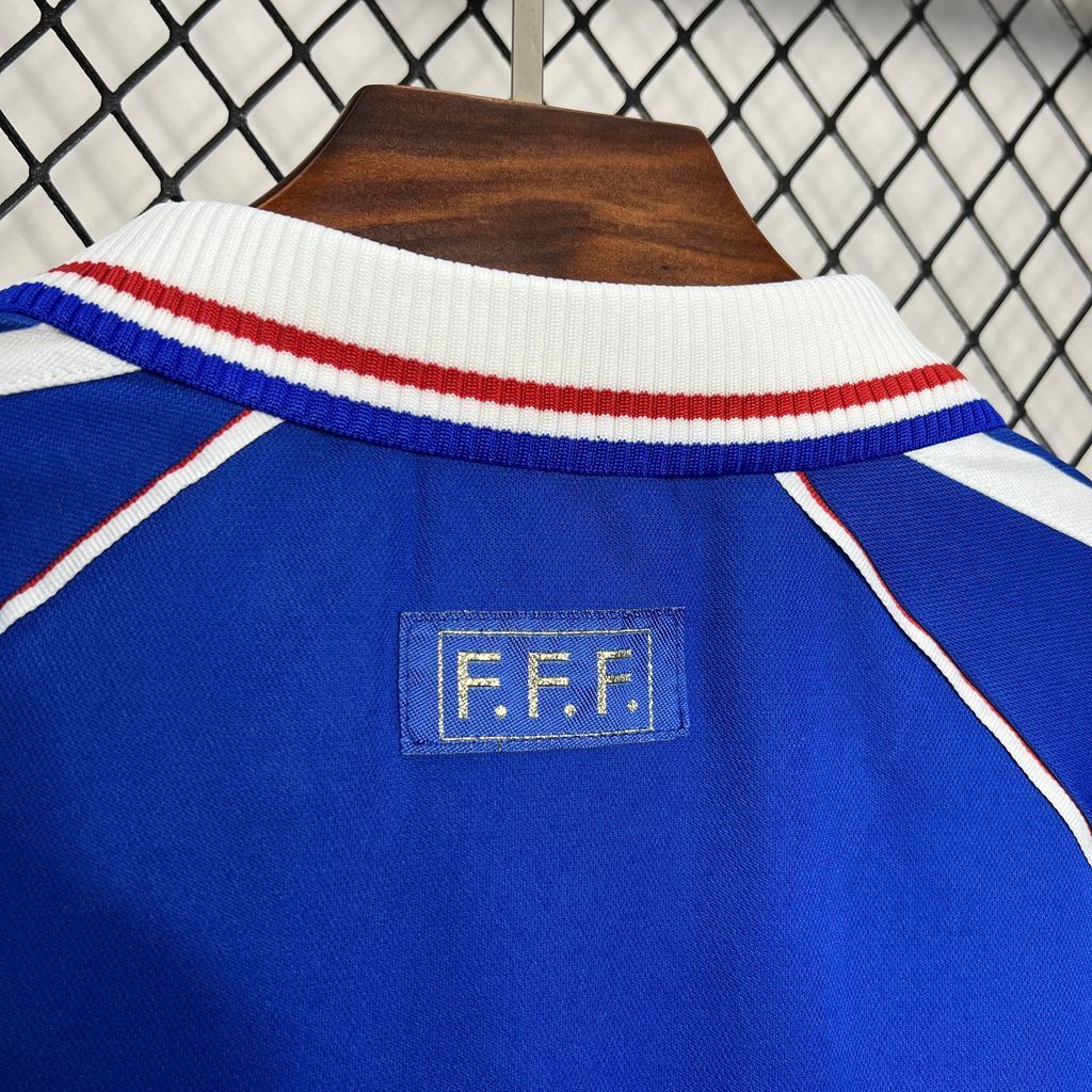 Blue France football jersey detail: white collar stripe with red and blue band trim.