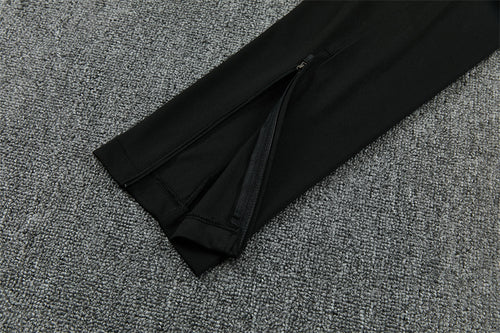Close-up of black track pants with elastic waistband and matte fabric