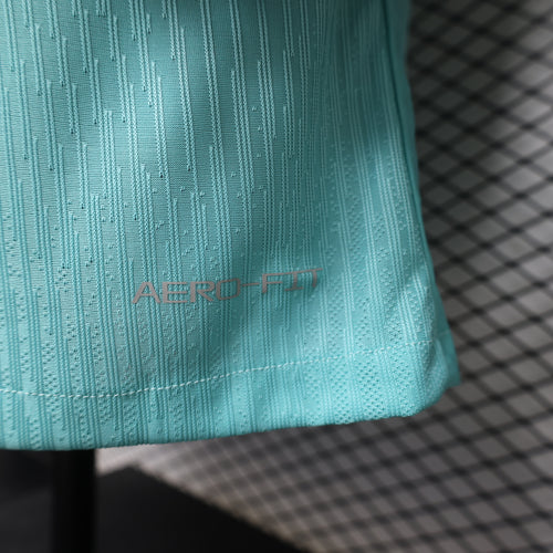 Turquoise training top hem with 'ENGINEERED' label