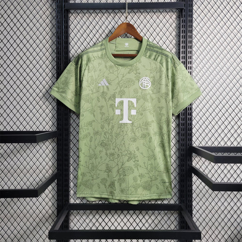 Light green Bayern Munich fan jersey with floral print, crew neck, adidas logo, crest, sponsor T