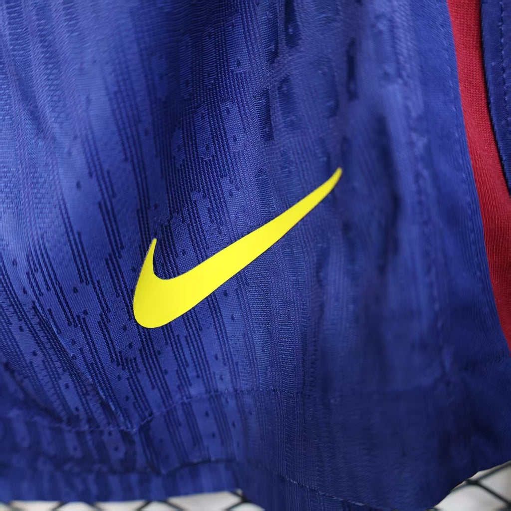 Blue player shorts with yellow Nike swoosh on textured fabric