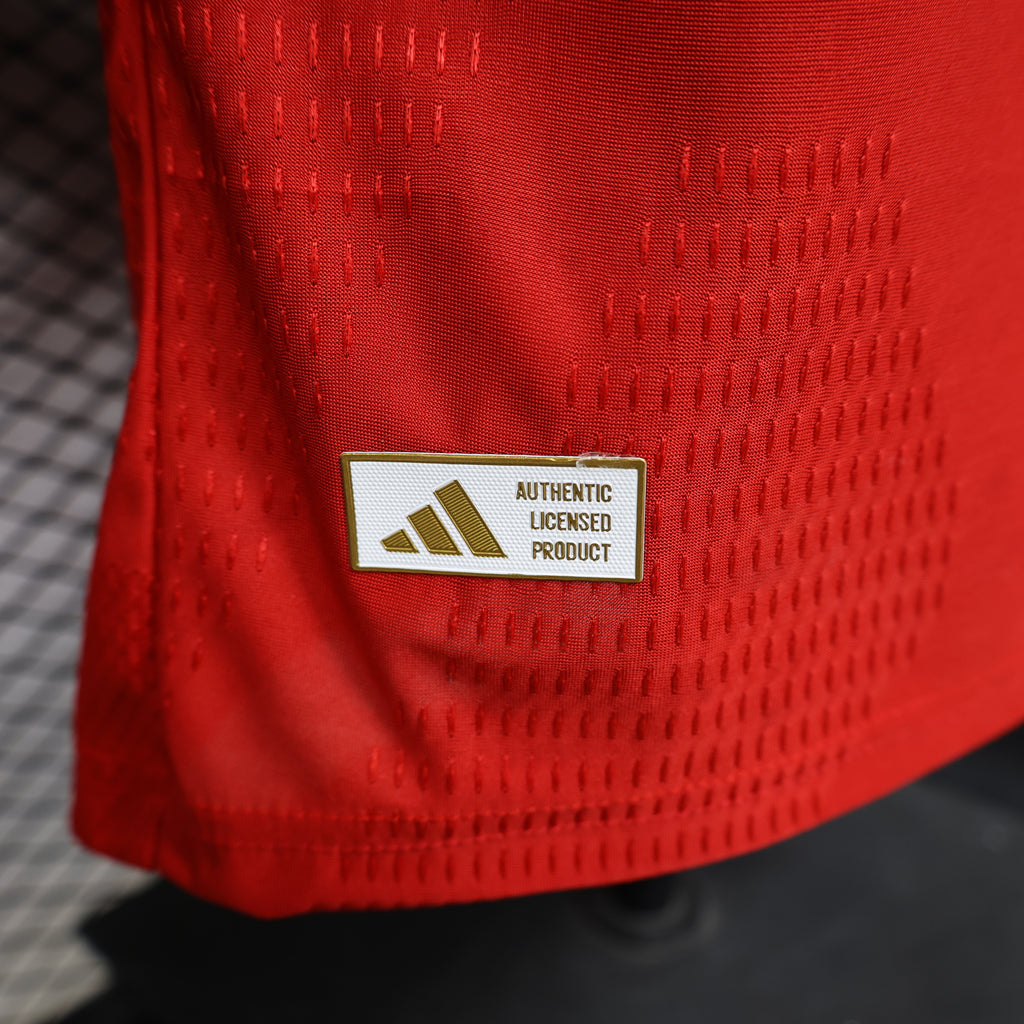 Arsenal home football jersey authenticity label on red fabric, Authentic Licensed Product