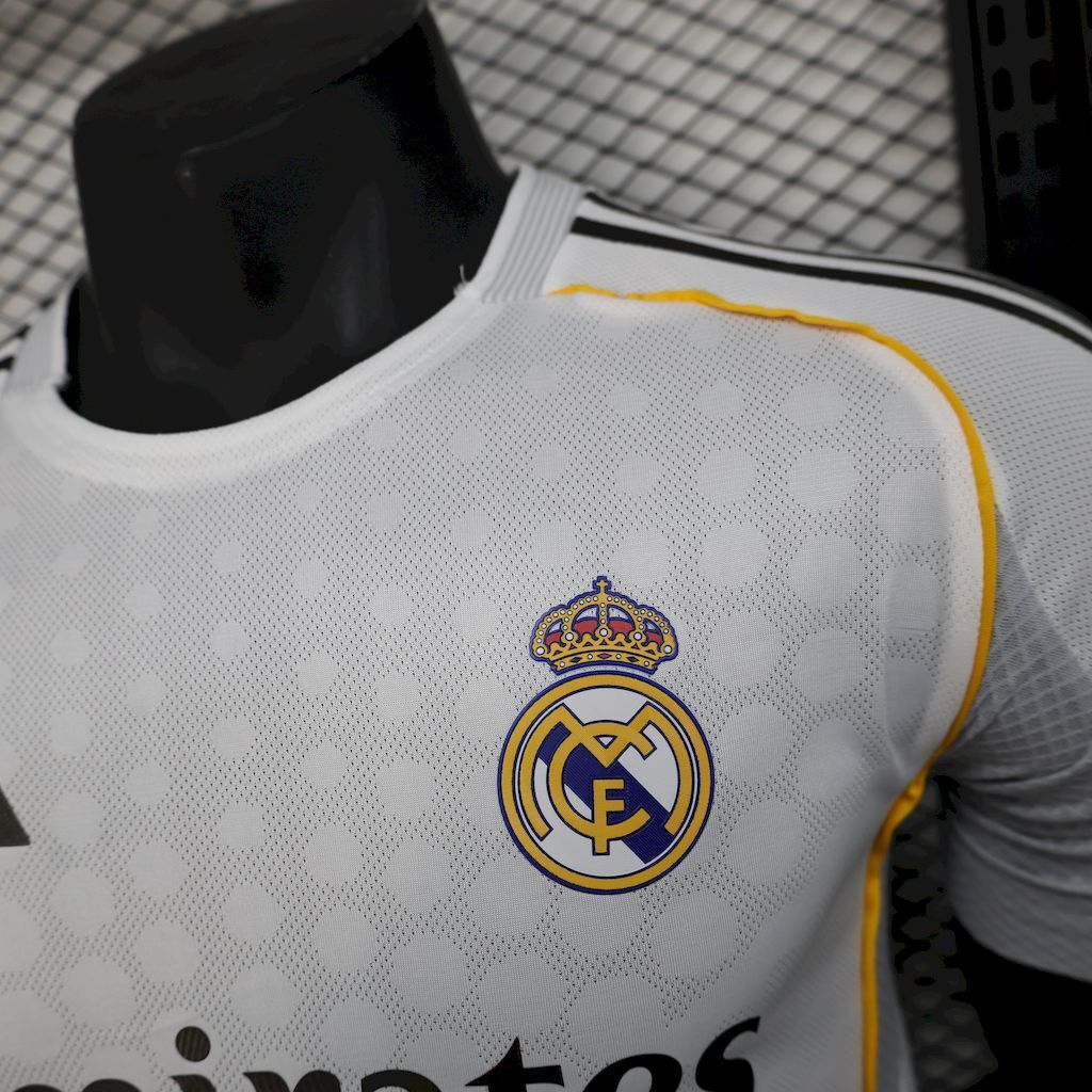 White jersey close-up of club crest and yellow-trim collar, adidas detail
