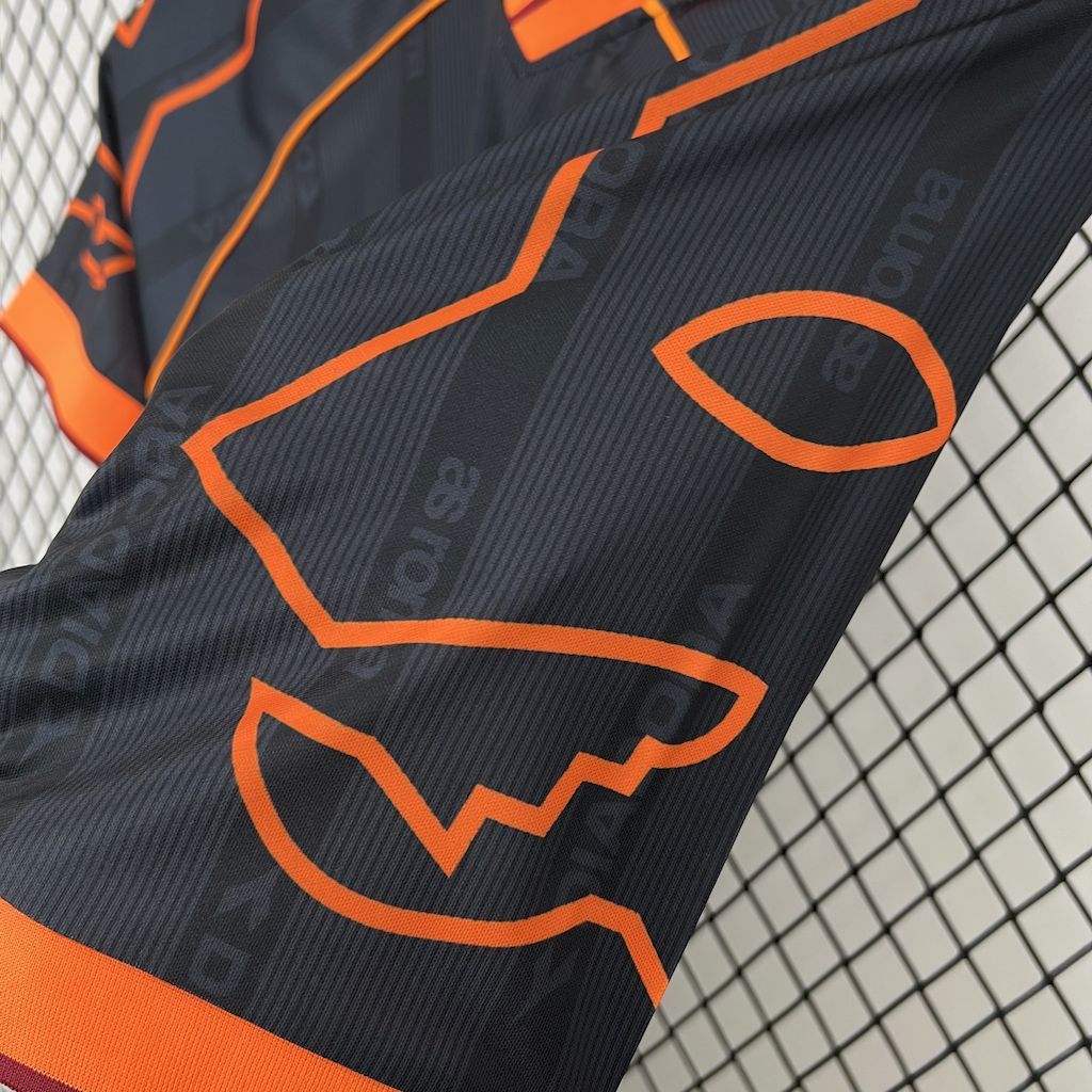 Retro football jersey close-up, textured navy fabric with orange graphic accents