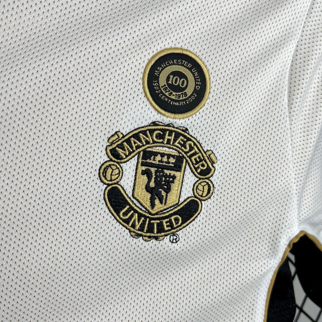Manchester United crest and 100-year centenary badge on white jersey chest