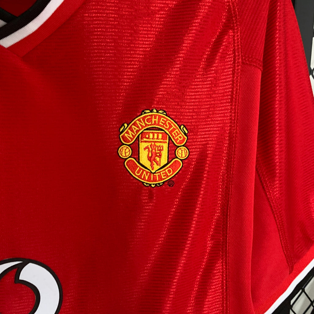 Red football shirt close-up of Manchester United club crest on chest