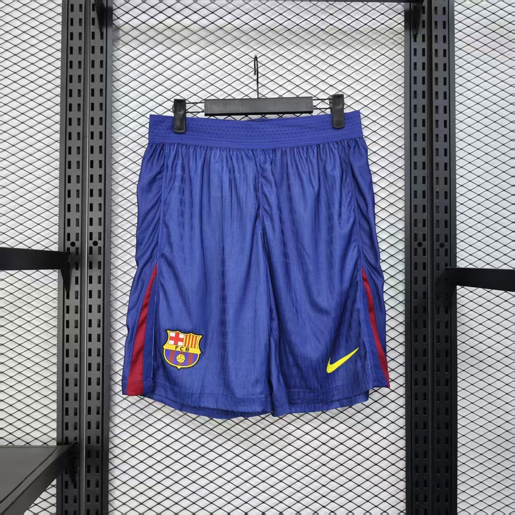 Blue player shorts with FC Barcelona crest and yellow Nike logo
