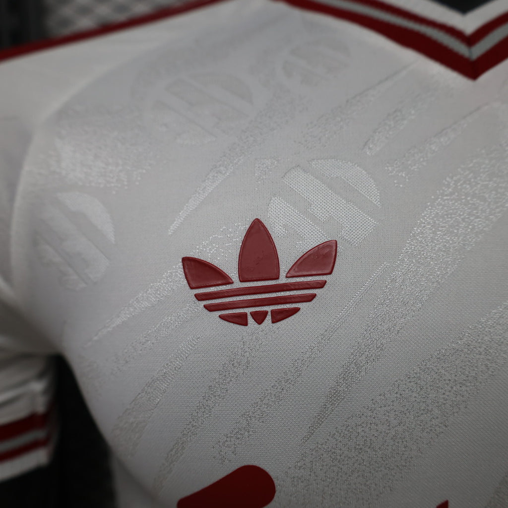White jersey fabric with red adidas trefoil emblem
