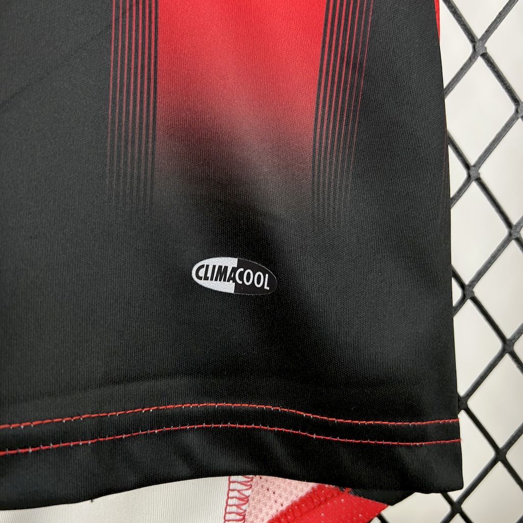 Black jersey fabric with CLIMACOOL label and red contrast stitching at hem