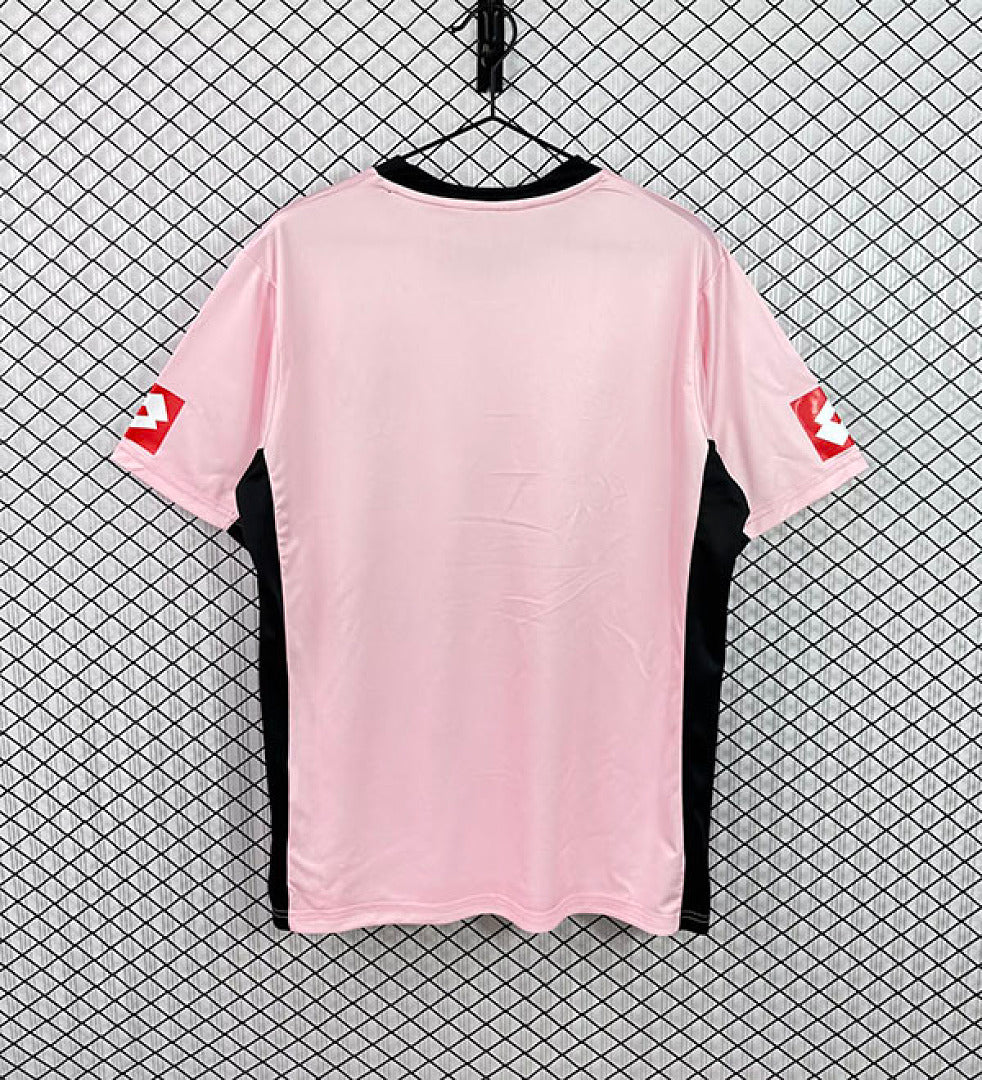Pink football jersey with black side panels and short sleeves, back view