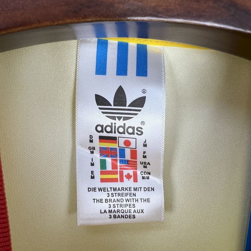 adidas size tag inside collar area of yellow soccer jersey