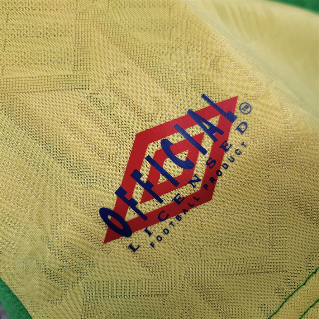Umbro sponsor logo on yellow-green fabric with textured pattern