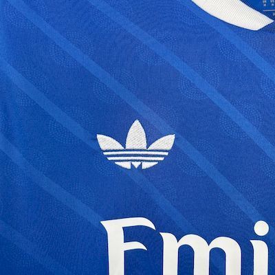 Blue Real Madrid jersey with white adidas trefoil logo and Emirates text