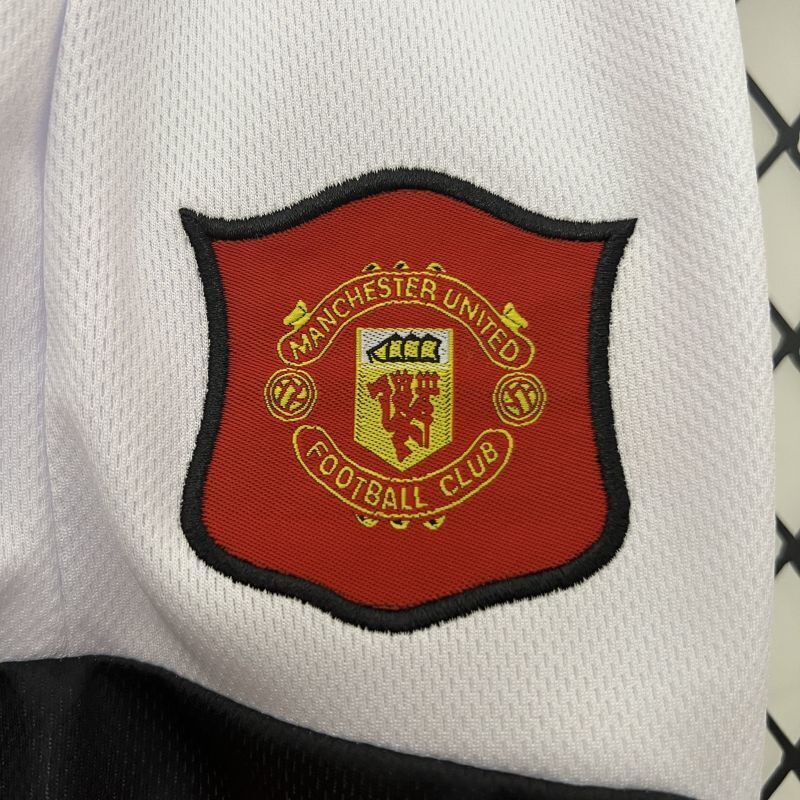 White kid shorts with embroidered Manchester United crest