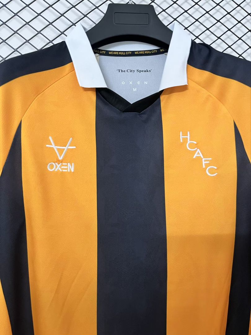 Home fan football shirt close-up with orange and black stripes and club logos on chest