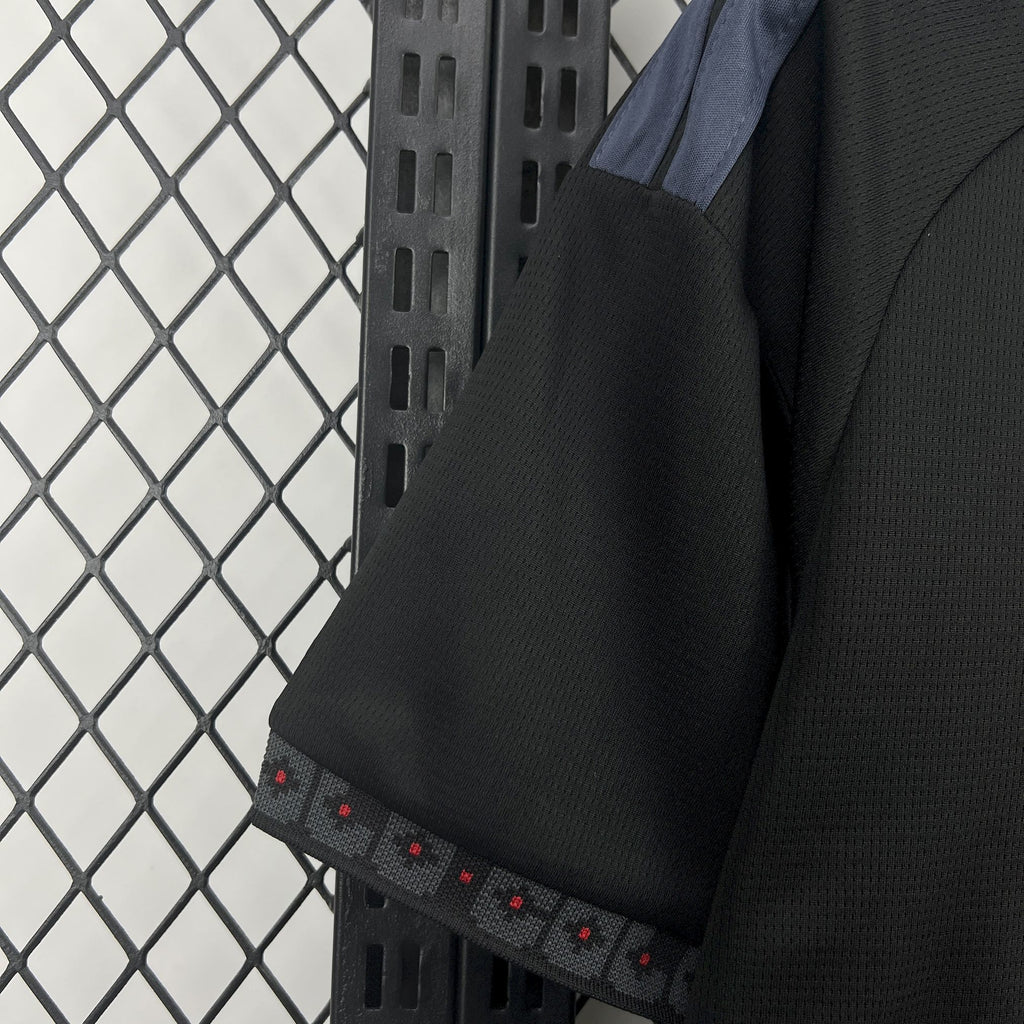 Black jersey sleeve cuff with patterned band and small red dot accents