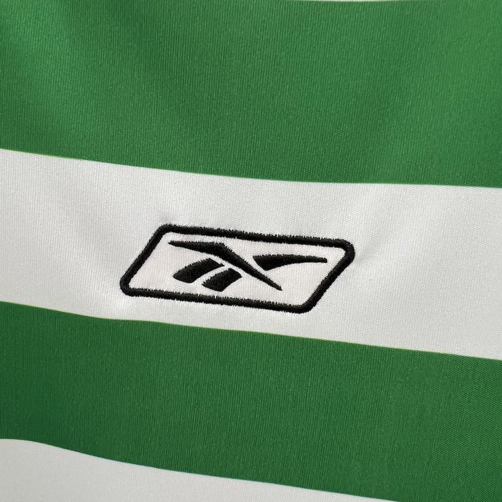 Sports apparel logo on green-and-white striped jersey