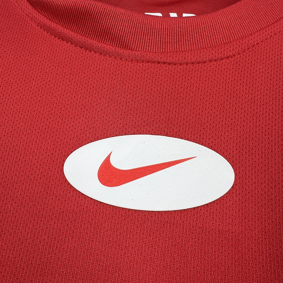 Red jersey chest with white Nike swoosh logo.