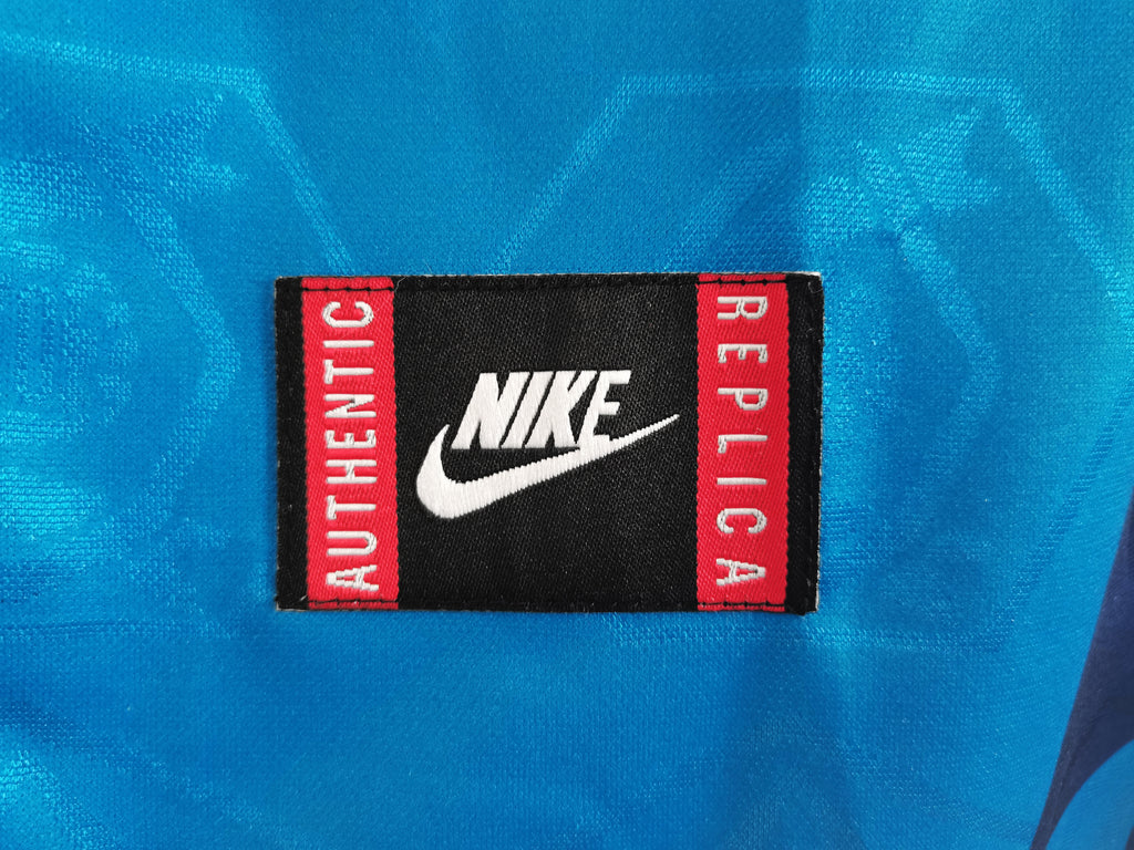 Nike woven neck label with 'AUTHENTIC' and 'REPUBLICA' text