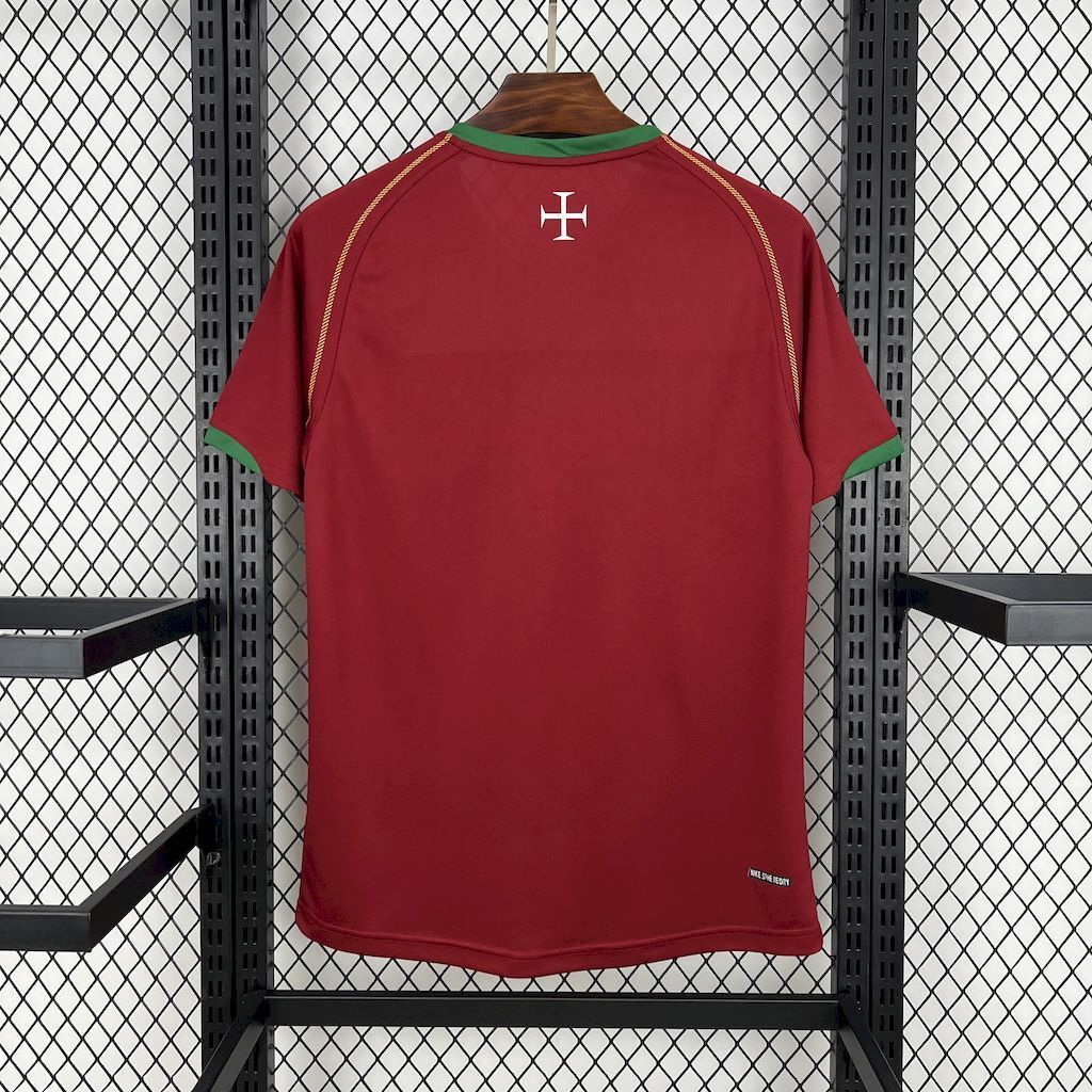 Maroon Portugal home soccer jersey back with white cross emblem and green collar trim